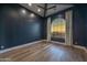 Serene bedroom featuring a vaulted ceiling, hardwood floors, and an arched window overlooking a scenic view at 28869 N 91St Ave, Peoria, AZ 85383