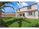 Spacious backyard featuring green grass, an outdoor patio, and a shade tree at 2901 E Iris Dr, Chandler, AZ 85286