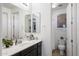 A bathroom with a dark vanity, white countertops, and a neutral-colored shower curtain at 2901 E Iris Dr, Chandler, AZ 85286
