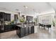 Gourmet kitchen with dark cabinetry, granite countertops, a large island, and stainless steel appliances at 2901 E Iris Dr, Chandler, AZ 85286