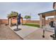 An open backyard with a concrete patio, a gazebo and artificial turf at 35598 N Murray Grey Dr, San Tan Valley, AZ 85143