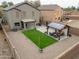 Wide angle shows a backyard oasis featuring artificial turf and a cozy pergola-covered seating area at 35598 N Murray Grey Dr, San Tan Valley, AZ 85143