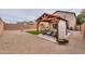 Backyard view of a wood gazebo with outdoor furniture and turf at 35598 N Murray Grey Dr, San Tan Valley, AZ 85143