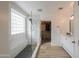 Bright bathroom with a glass-enclosed shower, bench, modern fixtures, and an open doorway to a walk-in closet at 35598 N Murray Grey Dr, San Tan Valley, AZ 85143