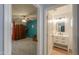 View into a bedroom through a doorway from a bathroom, featuring a bed and wardrobe at 35598 N Murray Grey Dr, San Tan Valley, AZ 85143