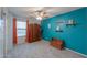 Bright bedroom with a ceiling fan, blue accent wall, and a large wooden wardrobe at 35598 N Murray Grey Dr, San Tan Valley, AZ 85143