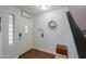 The bright entryway showcases a white front door, hardwood floors, and a decorative mirror at 35598 N Murray Grey Dr, San Tan Valley, AZ 85143