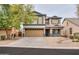 Inviting two-story home with a tan exterior, charming curb appeal and a two-car garage at 35598 N Murray Grey Dr, San Tan Valley, AZ 85143