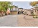 Two-story home with a desert style rock landscaped yard and a two car garage at 35598 N Murray Grey Dr, San Tan Valley, AZ 85143