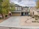 Two-story home with a desert style rock landscaped yard and a two car garage at 35598 N Murray Grey Dr, San Tan Valley, AZ 85143