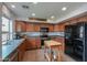 Spacious kitchen features wood cabinets, a large window, stainless appliances, and a butcher block island at 35598 N Murray Grey Dr, San Tan Valley, AZ 85143