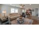 Comfortable living room layout with a sofa, armchairs, and a view into the adjacent dining and kitchen areas at 35598 N Murray Grey Dr, San Tan Valley, AZ 85143