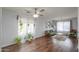 The naturally lit living room features hardwood floors, a ceiling fan, and comfortable seating at 35598 N Murray Grey Dr, San Tan Valley, AZ 85143