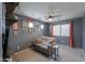 Comfortable living room with a couch, ceiling fan, and wall decor creating a relaxing atmosphere at 35598 N Murray Grey Dr, San Tan Valley, AZ 85143