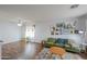 Spacious living room with hardwood floors, a cozy sofa, ceiling fan and lots of natural light at 35598 N Murray Grey Dr, San Tan Valley, AZ 85143