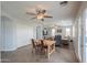 Open-concept living space featuring a dining area and living room with neutral walls and tiled floors at 35598 N Murray Grey Dr, San Tan Valley, AZ 85143