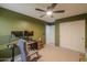 Office featuring olive green walls, a ceiling fan, and a modern computer setup at 35598 N Murray Grey Dr, San Tan Valley, AZ 85143