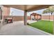Covered patio with artificial grass, a gazebo, and a barbecue for outdoor living at 35598 N Murray Grey Dr, San Tan Valley, AZ 85143