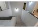 Well-lit staircase with neutral carpet and modern black and white design, leading to the upper level of the home at 35598 N Murray Grey Dr, San Tan Valley, AZ 85143