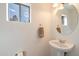 Small bathroom with pedestal sink and oval mirror at 3703 E Mitchell Dr, Phoenix, AZ 85018