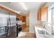Modern kitchen with stainless steel appliances and wood cabinets at 3703 E Mitchell Dr, Phoenix, AZ 85018