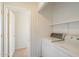 Laundry room with washer, dryer, and storage shelves at 3703 E Mitchell Dr, Phoenix, AZ 85018