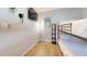 Small bedroom with bunk bed, TV, and light wood floors at 3714 E Amelia Ave, Phoenix, AZ 85018
