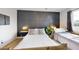 Bedroom with a wooden bed frame and dark accent wall at 3714 E Amelia Ave, Phoenix, AZ 85018