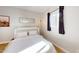 Bedroom with a murphy bed and window with dark curtains at 3714 E Amelia Ave, Phoenix, AZ 85018