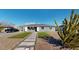 Cute bungalow with artificial turf, stone pathway, and mature cactus at 3714 E Amelia Ave, Phoenix, AZ 85018