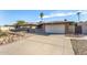 Front view of a ranch home with a two-car garage and gravel driveway at 4511 W Sandra Ter, Glendale, AZ 85306