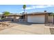 House exterior showcasing a two-car garage and well maintained yard at 4511 W Sandra Ter, Glendale, AZ 85306