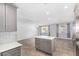 Kitchen island with white countertop and gray cabinets at 4511 W Sandra Ter, Glendale, AZ 85306