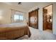 Guest bedroom with barn door and ensuite bathroom at 4590 S Gold Canyon Dr, Gold Canyon, AZ 85118