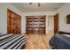 Bedroom with two twin beds, a large bookcase, and hardwood floors at 4590 S Gold Canyon Dr, Gold Canyon, AZ 85118