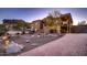 Brick paver driveway leading to a beautiful two-story home with desert landscaping at 4590 S Gold Canyon Dr, Gold Canyon, AZ 85118