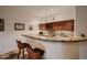 Basement wet bar with wood cabinets, tile counters, and a microwave at 4590 S Gold Canyon Dr, Gold Canyon, AZ 85118