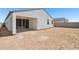 New backyard featuring dirt, patio, block wall, and partial view of neighboring houses at 46905 W Old Timer Rd, Maricopa, AZ 85139