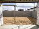 A framed view of the backyard and block wall, with scaffolding and fresh desert landscaping at 46905 W Old Timer Rd, Maricopa, AZ 85139