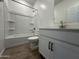 Bathroom featuring a tub/shower combo, sleek vanity with white cabinets, and modern fixtures at 46905 W Old Timer Rd, Maricopa, AZ 85139