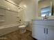 Clean, modern bathroom with shower-tub combo, vanity, and contemporary fixtures at 46905 W Old Timer Rd, Maricopa, AZ 85139