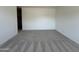 Bright, spacious bedroom featuring neutral carpeting and a walk-in closet for ample storage at 46905 W Old Timer Rd, Maricopa, AZ 85139