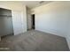 Bedroom featuring plush carpeting, closet, neutral paint, and a bright and airy feel at 46905 W Old Timer Rd, Maricopa, AZ 85139