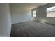Spacious bedroom with carpeted floors, two windows and ample natural light at 46905 W Old Timer Rd, Maricopa, AZ 85139