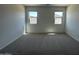 Well-lit bedroom with plush carpeting and dual windows that offer plenty of natural light at 46905 W Old Timer Rd, Maricopa, AZ 85139