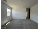 Neutral carpeted bedroom featuring a window that lets in natural light and two electrical outlets at 46905 W Old Timer Rd, Maricopa, AZ 85139