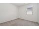 Empty bedroom with gray carpet and a bright window at 46905 W Old Timer Rd, Maricopa, AZ 85139