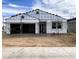 Exterior view of a home under construction, featuring a garage, scaffolding and wrapped in protective material at 46905 W Old Timer Rd, Maricopa, AZ 85139