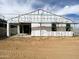 A side view of a home under construction with a partial view of the backyard through a doorway at 46905 W Old Timer Rd, Maricopa, AZ 85139