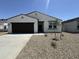 Charming single-story home with a low-maintenance desert landscape and a two car garage at 46905 W Old Timer Rd, Maricopa, AZ 85139
